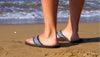 standing by the ocean with flip flops