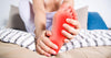Lady holding foot due to plantar fasciitis heel pain