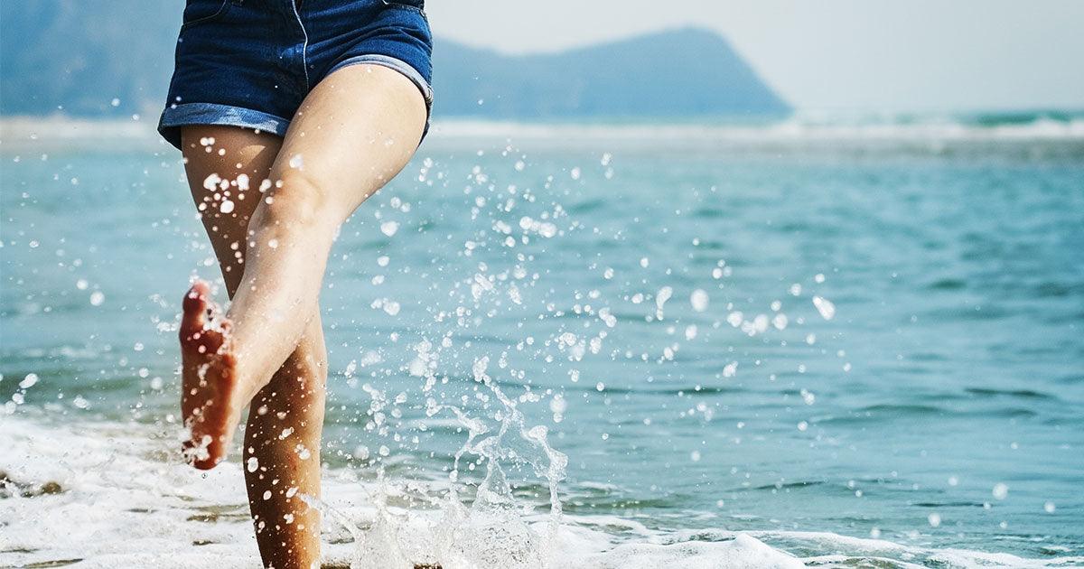 Girl splashing water by the beach