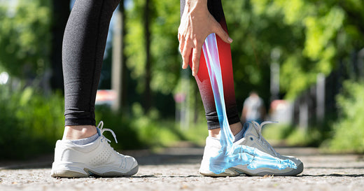 man runner with hand on calf