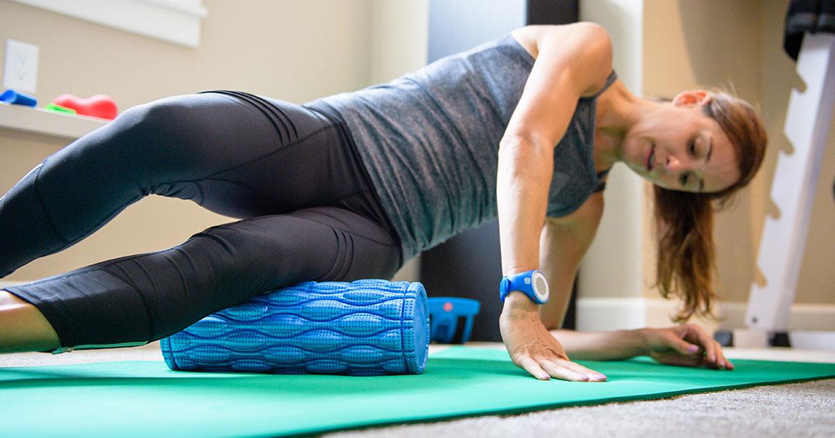 Athlete Kara Goucher using the ProStretch Addaday Nonagon Foam Roller