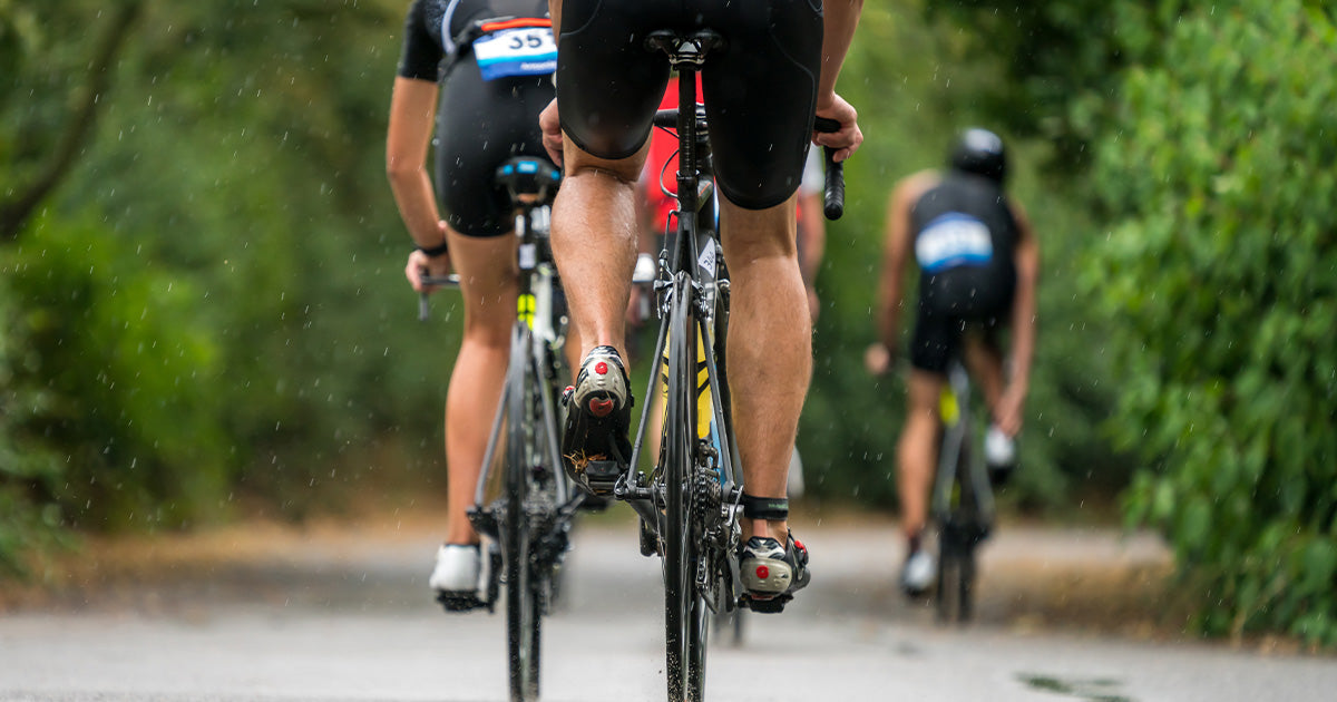 cyclists cycling through a trail 