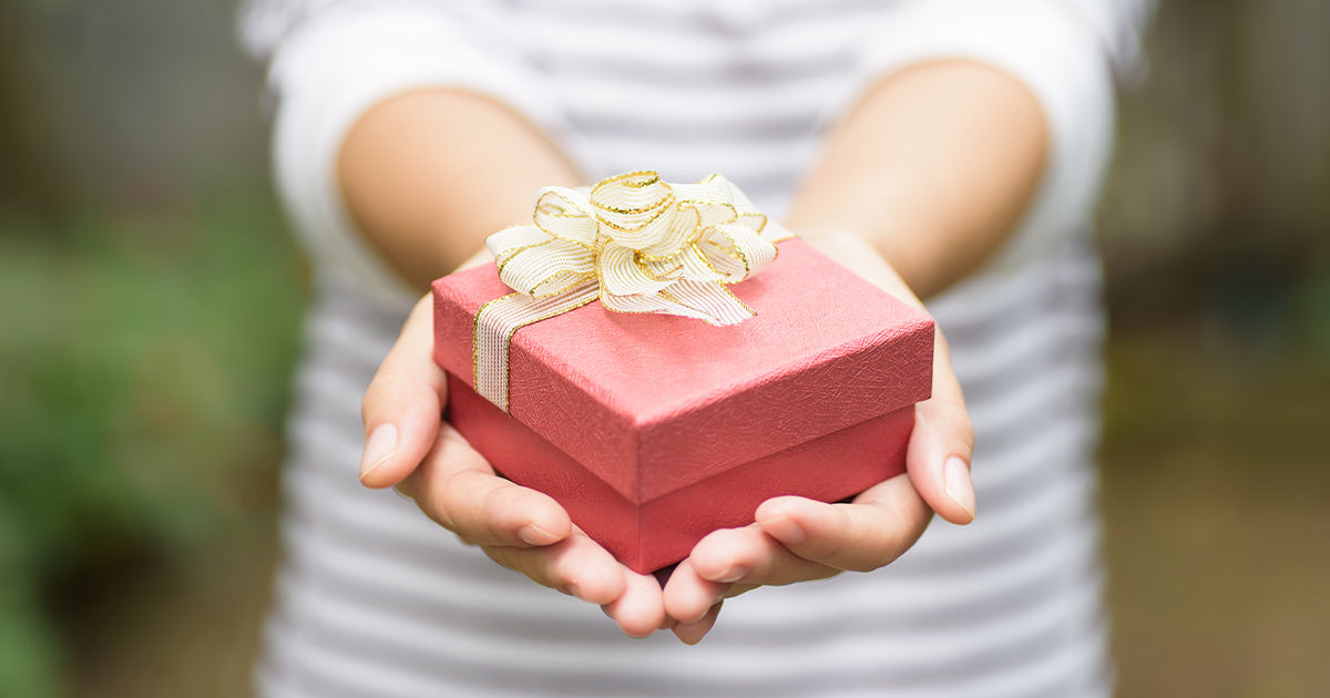 red holiday gift box on hand
