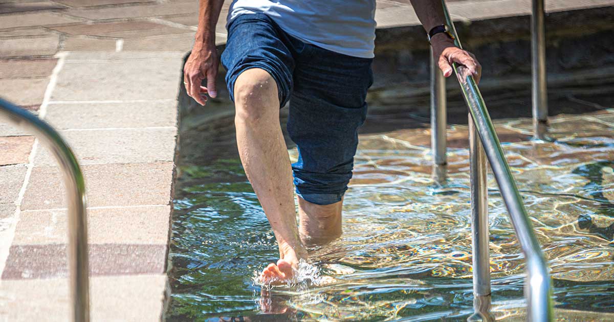 man getting in the pool for low impact exercises