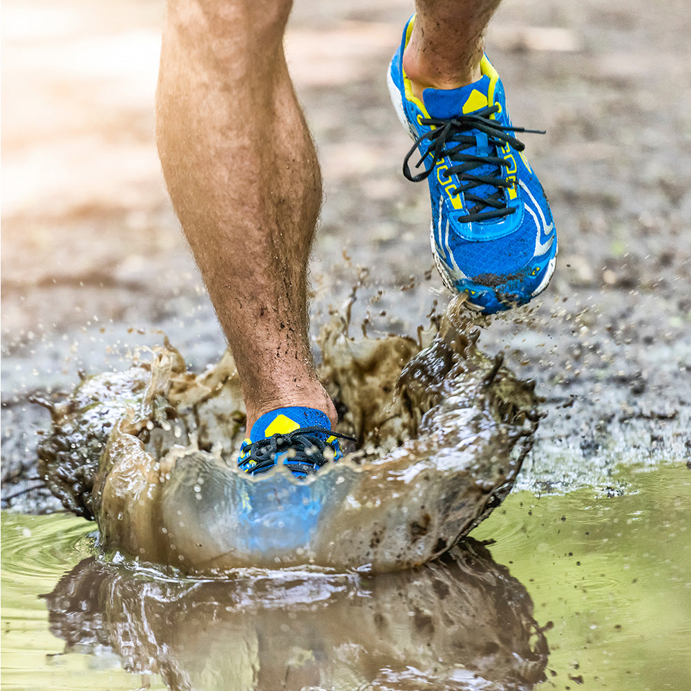 Runner stepping in mud