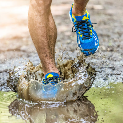 Runner stepping on mud.