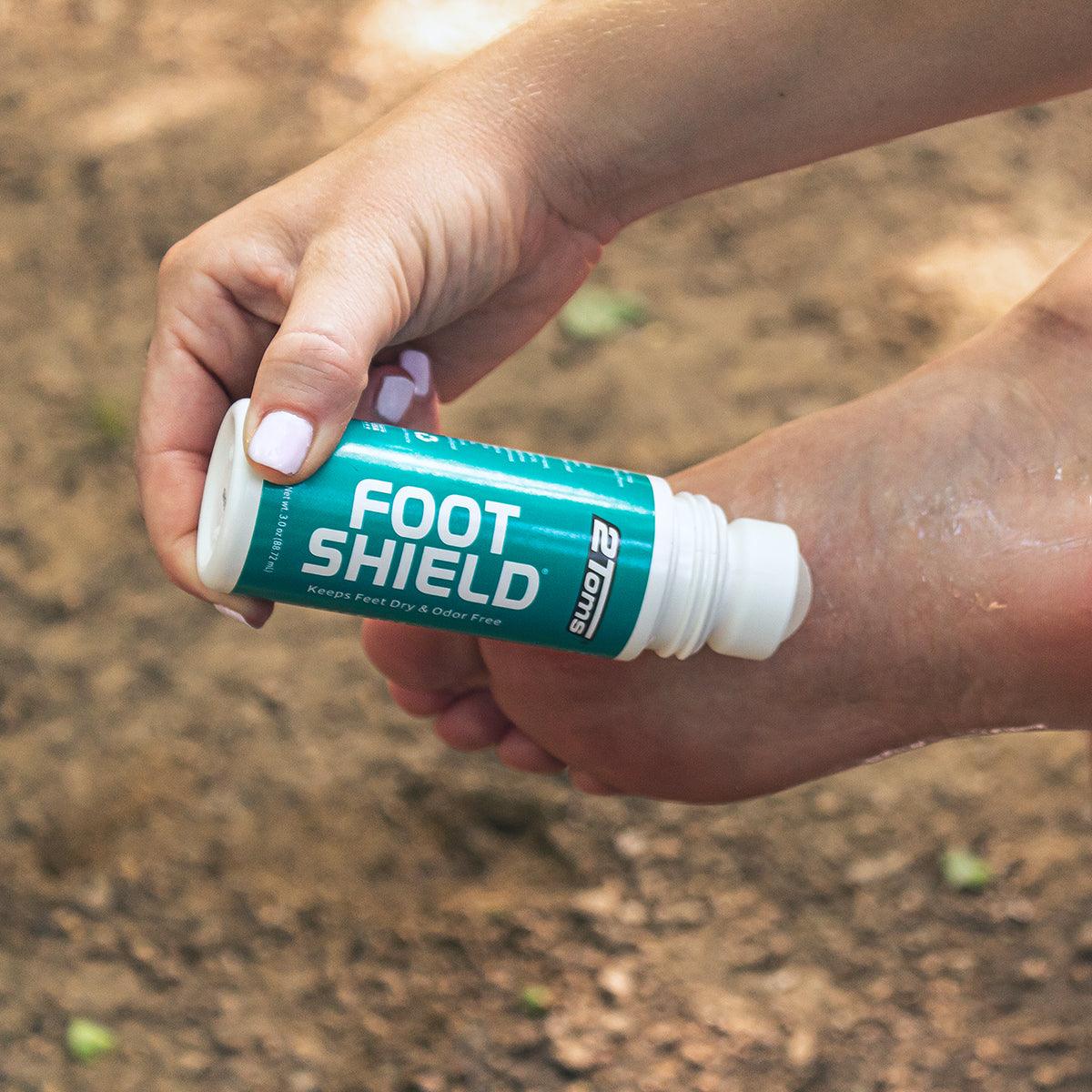 Image of women applying 2Toms FootShield to the bottom of her foot.