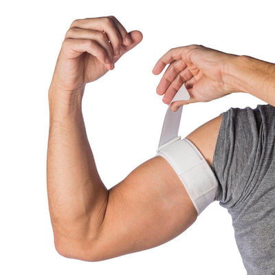 Man putting on the Cho-Pat Upper Arm Strap